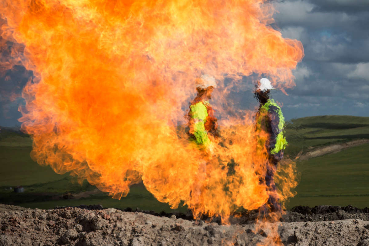 A gas flare is seen at an oil well site on July 26, 2013, outside Williston, North Dakota.
