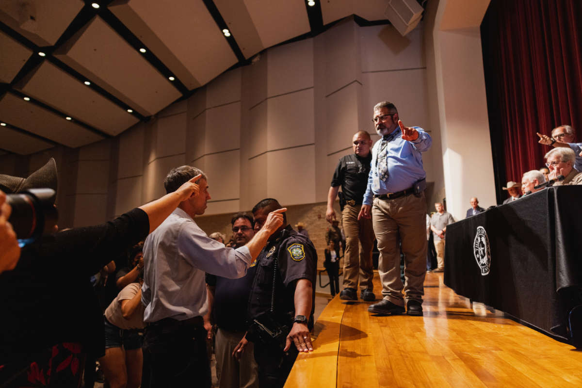 Democratic gubernatorial candidate Beto O'Rourke, left, interrupts a press conference held by Texas Gov. Greg Abbott following a shooting at Robb Elementary School which left 21 dead including 19 children, on May 25, 2022, in Uvalde, Texas.