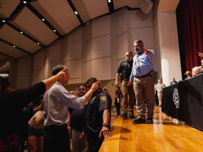 Democratic gubernatorial candidate Beto O'Rourke, left, interrupts a press conference held by Texas Gov. Greg Abbott following a shooting at Robb Elementary School which left 21 dead including 19 children, on May 25, 2022, in Uvalde, Texas.