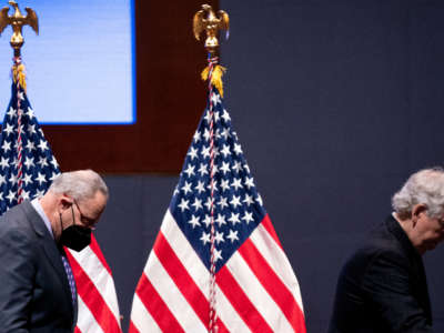 Majority Leader Charles Schumer and Minority Leader Mitch McConnell leave the stage after addressing the National Prayer Breakfast at the U.S. Capitol on February 3, 2022, in Washington, D.C.