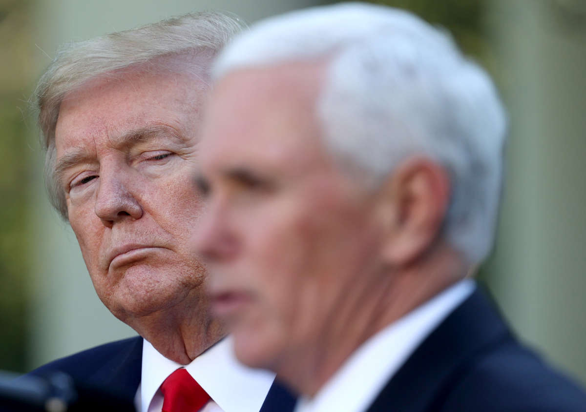 President Donald Trump listens as Vice President Mike Pence answers questions in the Rose Garden of the White House on April 27, 2020, in Washington, D.C.