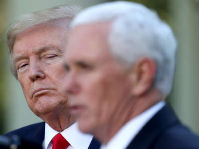 President Donald Trump listens as Vice President Mike Pence answers questions in the Rose Garden of the White House on April 27, 2020, in Washington, D.C.