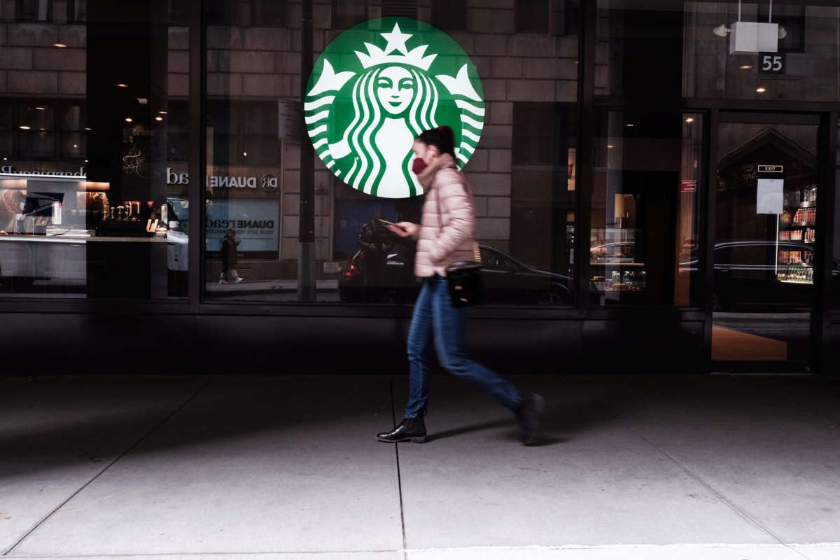 A woman walks by a starbucks location