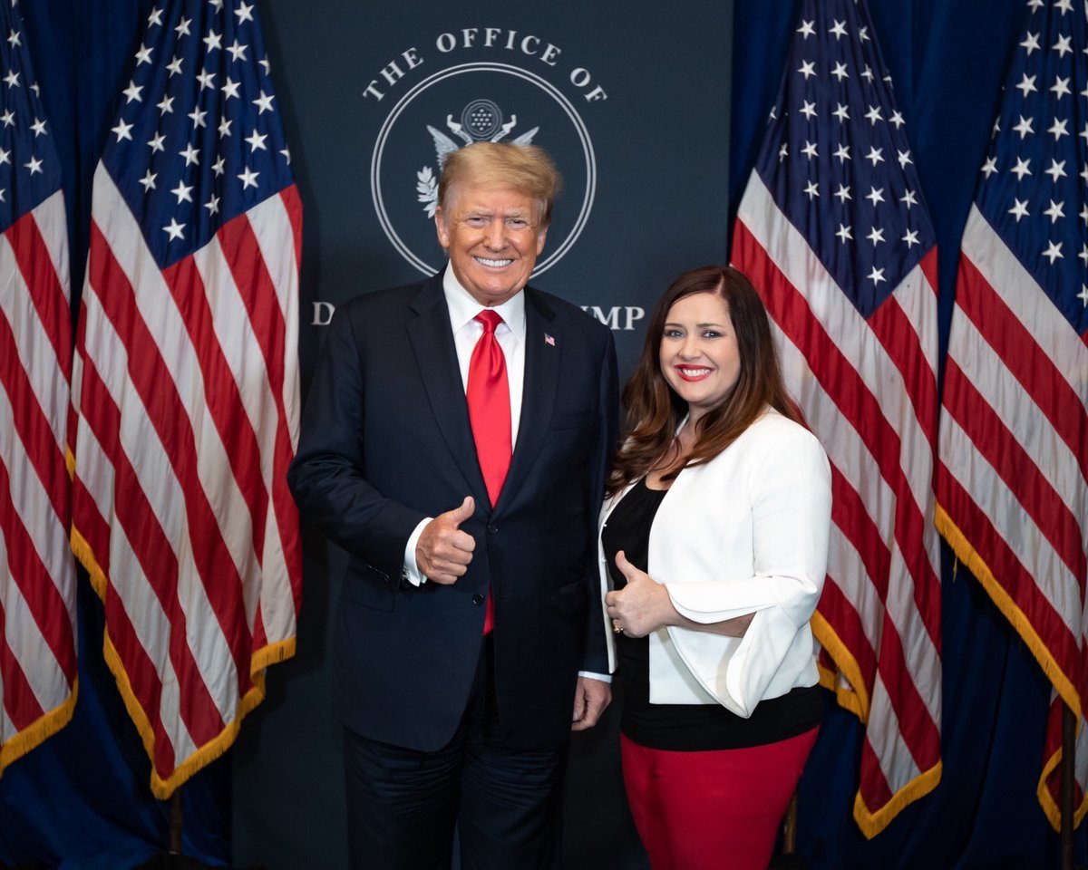 Republican gubernatorial candidate Kandiss Taylor stands next to former president Donald Trump.