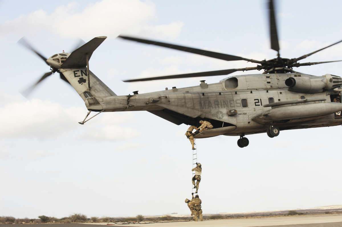 AFRICOM soldiers perform a combat and extraction exercise in a plane above a desert