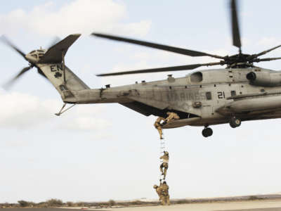 AFRICOM soldiers perform a combat and extraction exercise in a plane above a desert