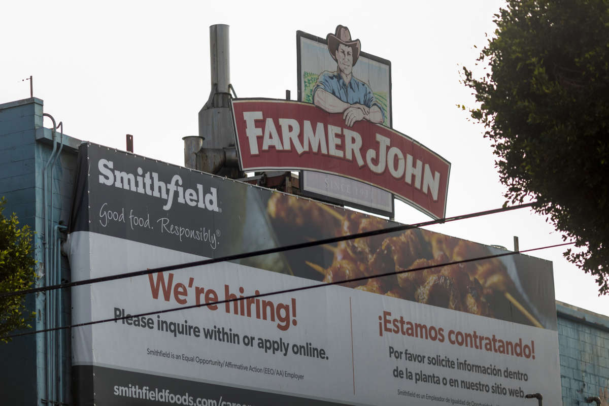 A sign on the Farmer John slaughterhouse advertises job openings after 153 workers tested positive for COVID-19, on May 26, 2020, in Vernon, California.