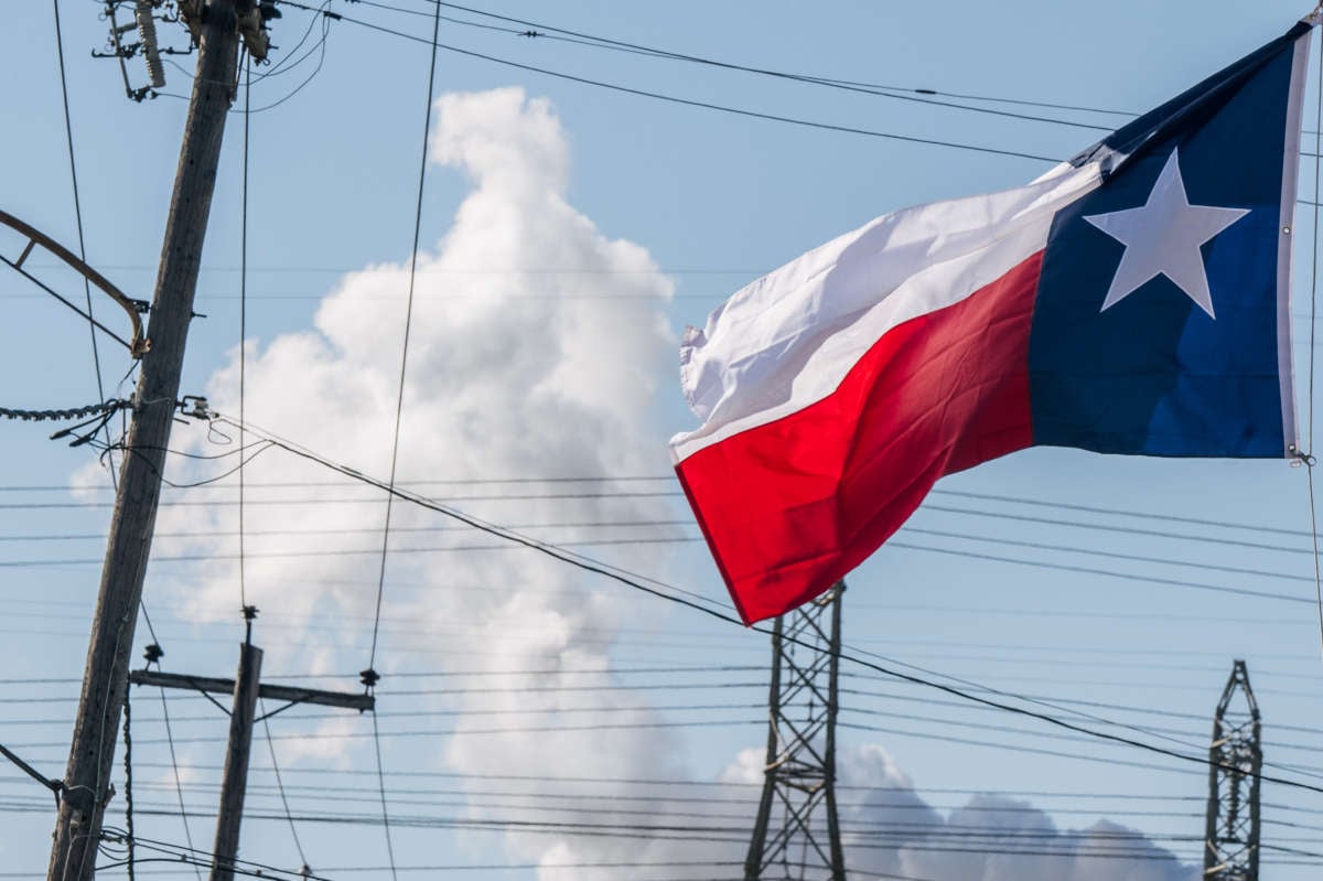 The Texas state flag is seen near an oil refinery on January 21, 2022, in Houston, Texas.