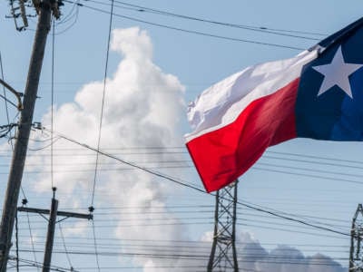 The Texas state flag is seen near an oil refinery on January 21, 2022, in Houston, Texas.