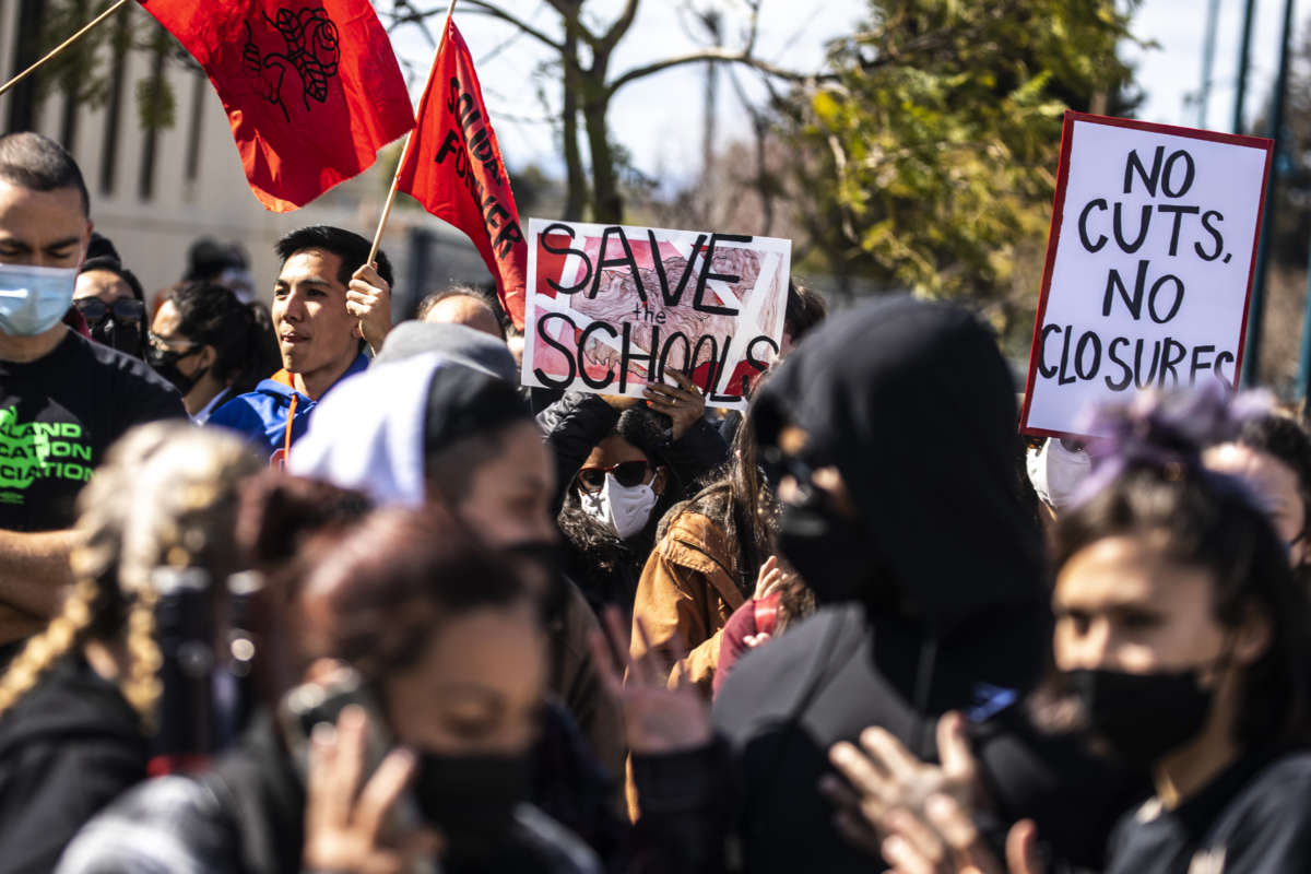 Demonstrators rally outside Roots International Academy during a protest against Oakland Unified School District's plan to close schools in Oakland, California, on March 5, 2022.