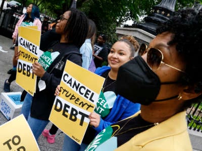 Student loan borrowers gather near The White House to tell President Biden to cancel student debt on May 12, 2022, in Washington, D.C.