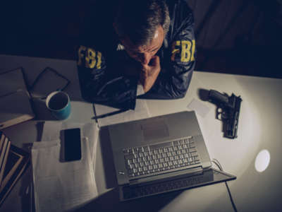 FBI agent looks at laptop computer