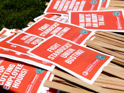 Picket signs are left for people to grab during the 'Fight Starbucks' Union Busting' rally and march in Seattle, Washington, on April 23, 2022.