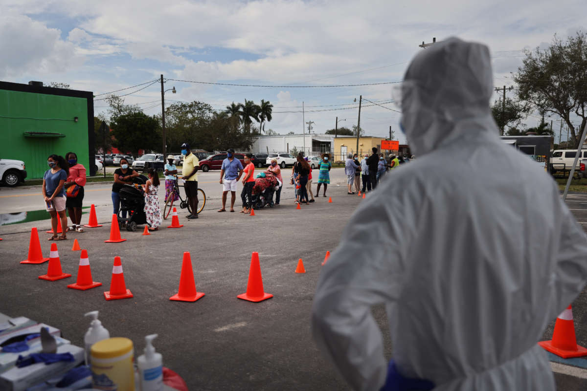 People line up to receive a rapid COVID-19 test amongst the agricultural community on February 17, 2021, in Immokalee, Florida.