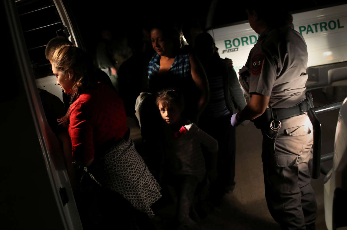 U.S. Border Patrol agents detain a group of Central American asylum seekers near the U.S.-Mexico border on June 12, 2018, in McAllen, Texas.