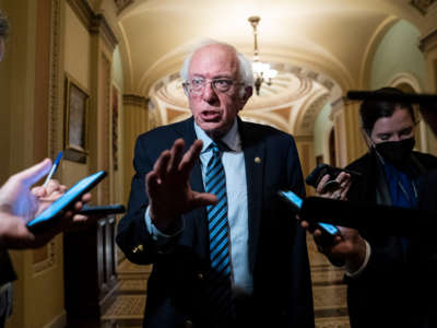 Sen. Bernie Sanders talks with reporters on Capitol Hill on October 26, 2021, in Washington, D.C.