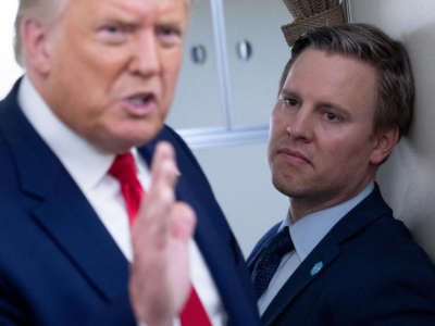 Campaign manager Bill Stepien stands alongside President Donald Trump as he speaks with reporters aboard Air Force One as he flies from Manchester, New Hampshire, to Joint Base Andrews in Maryland on August 28, 2020.