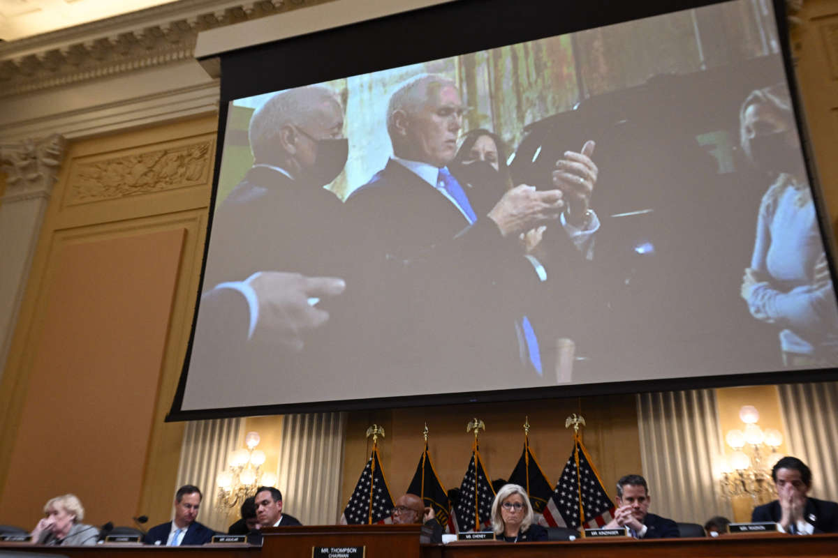 An image on a screen shows former Vice President Mike Pence looking at his phone as he shelters in a secure underground location after being evacuated from the Senate chamber on January 6, 2021, during a hearing of the U.S. House Select Committee to Investigate the January 6 Attack on the U.S. Capitol, on Capitol Hill in Washington, D.C., on June 16, 2022.