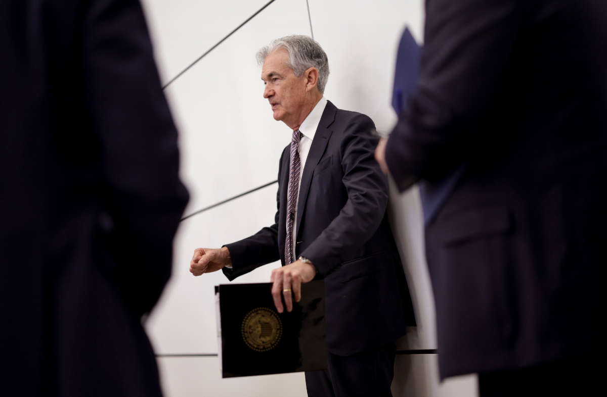 Federal Reserve Chairman Jerome Powell talks to staff as he waits to deliver remarks at the Conference on the International Roles of the U.S. Dollar, on June 17, 2022, in Washington, D.C.