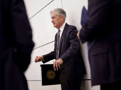 Federal Reserve Chairman Jerome Powell talks to staff as he waits to deliver remarks at the Conference on the International Roles of the U.S. Dollar, on June 17, 2022, in Washington, D.C.