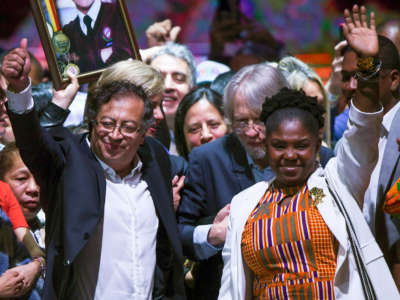 Newly elected Colombian President Gustavo Petro, left, and his running mate Francia Marquez celebrate at the Movistar Arena in Bogota, on June 19, 2022, after winning the presidential runoff election on June 19, 2022.