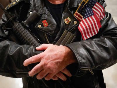 A second amendment protester stands in the rotunda of the State Capitol holding a semi-automatic rifle on January 31, 2020, in Frankfort, Kentucky.