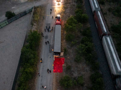 In this aerial view, members of law enforcement investigate a tractor trailer on June 27, 2022, in San Antonio, Texas.