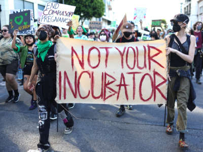 Abortion rights supporters march while protesting against the recent U.S. Supreme Court decision to end federal abortion rights protections on June 27, 2022, in Los Angeles, California.