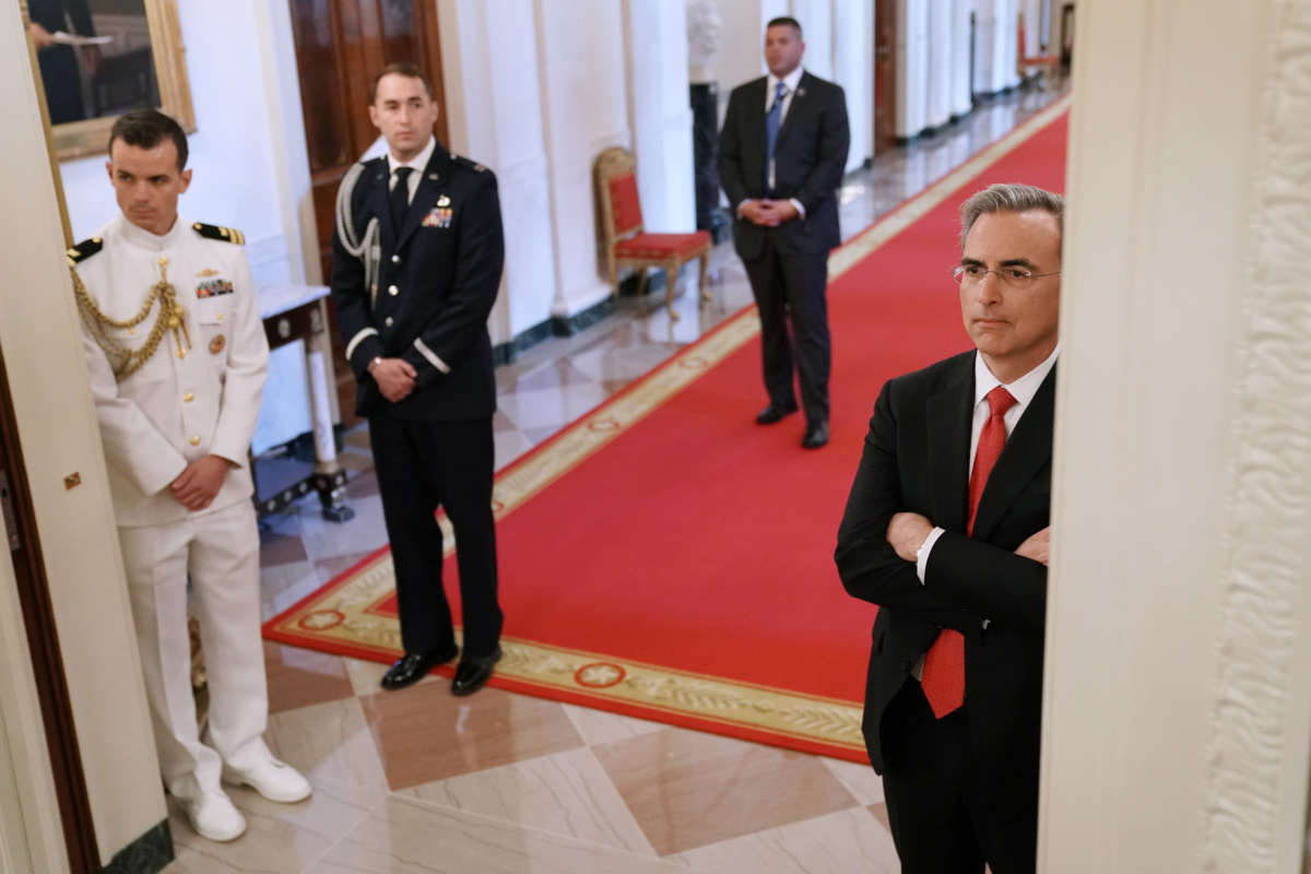 White House Counsel Pat Cipollone, right, watches the Public Safety Officer Medal of Valor presentation ceremony from the hallway outside the East Room of the White House on May 22, 2019, in Washington, D.C.