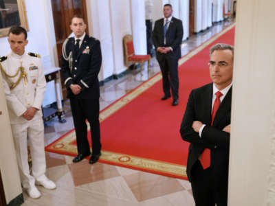 White House Counsel Pat Cipollone, right, watches the Public Safety Officer Medal of Valor presentation ceremony from the hallway outside the East Room of the White House on May 22, 2019, in Washington, D.C.
