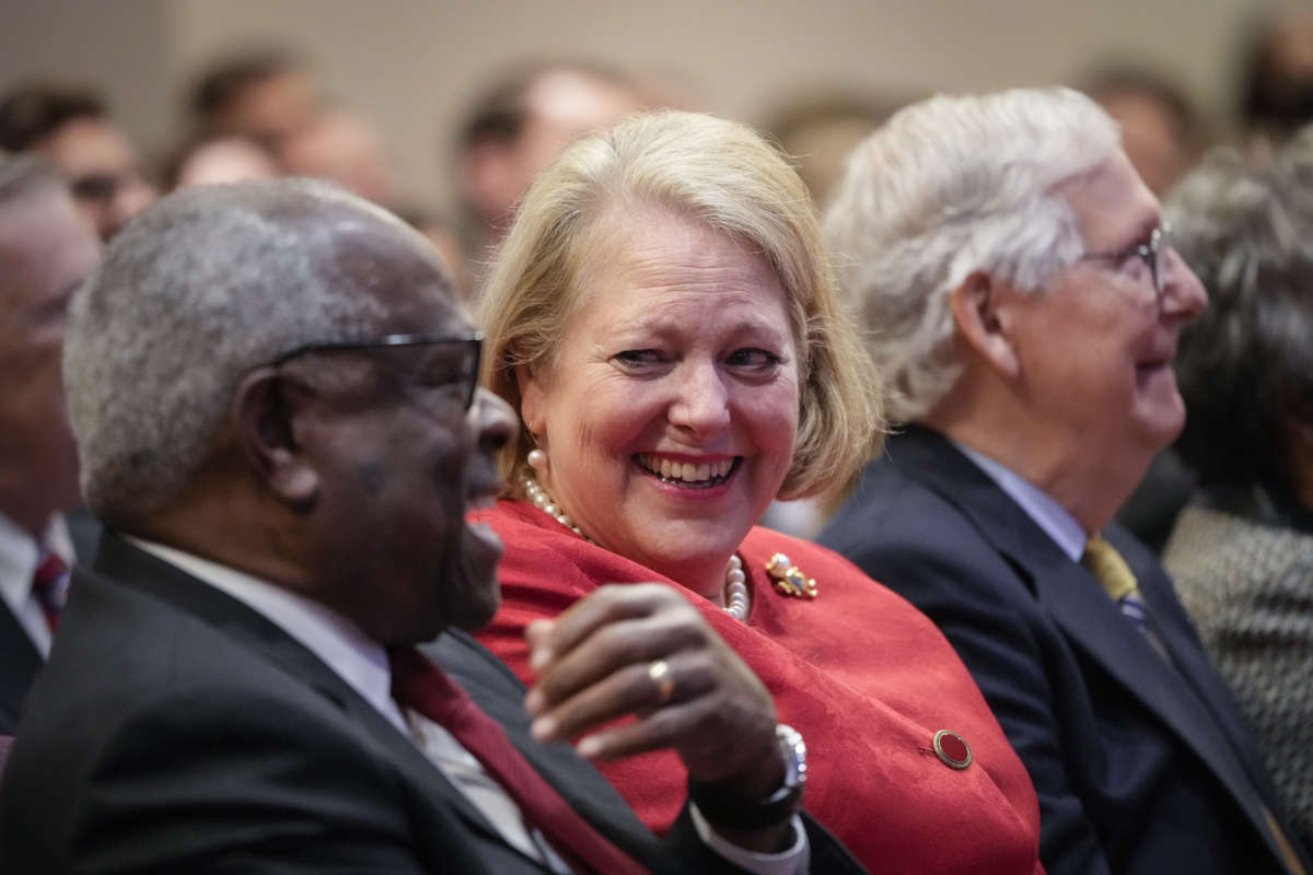 Associate Supreme Court Justice Clarence Thomas sits with his wife and right-wing activist Virginia Thomas while he waits to speak at the Heritage Foundation on October 21, 2021, in Washington, D.C.