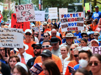 Protesters demanding action on gun violence participate in a "March For Our Lives" rally in Orlando, Florida, on June 11, 2022.