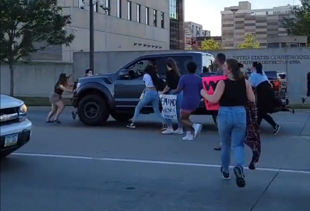 A driver is seen running into abortion rights defenders in Cedar Rapids, Iowa on June 24, 2022.