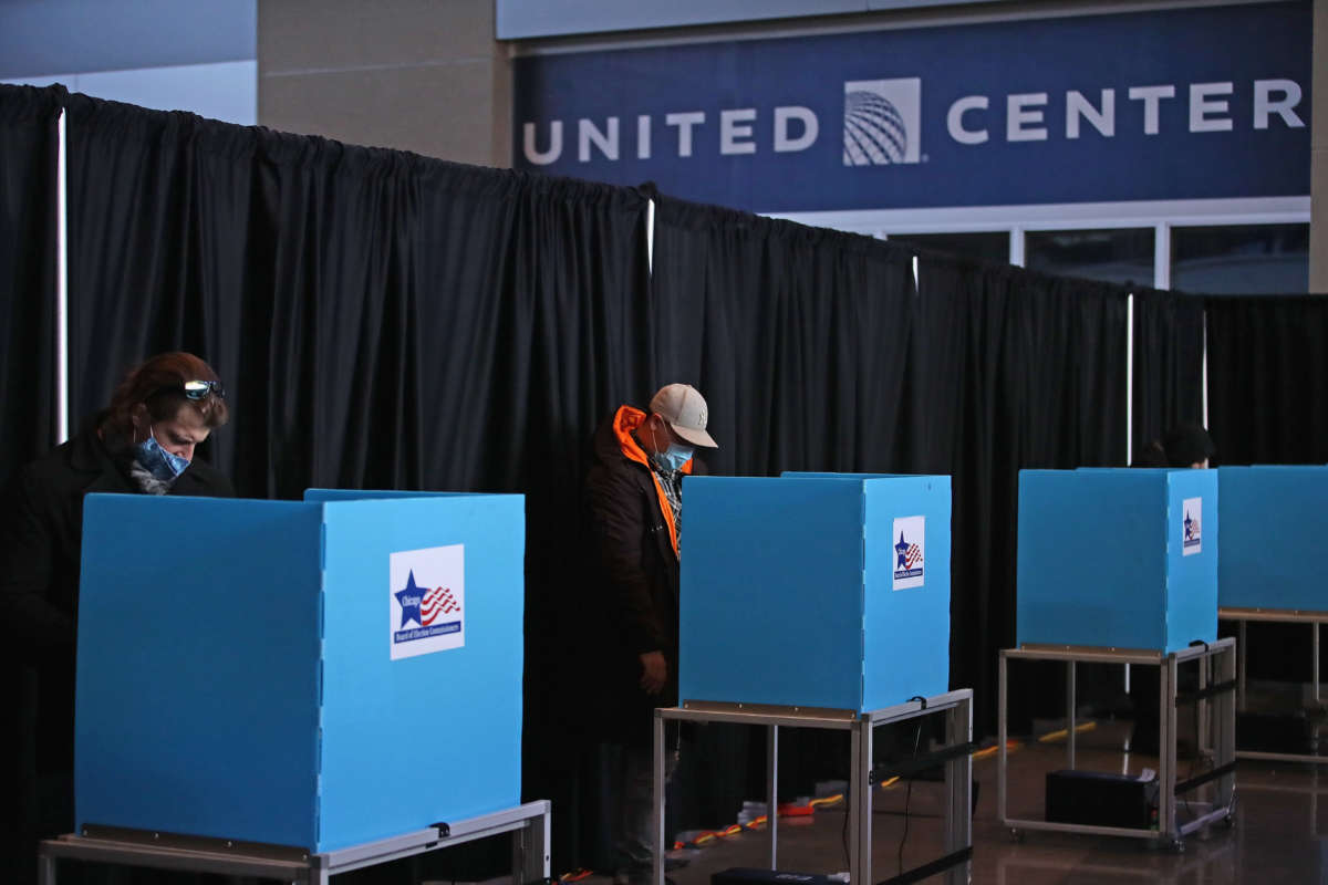 Voters use socially distanced voting machines set up in the east atrium of the United Center where a polling place with 70 machines was set up for the first time on November 03, 2020 in Chicago, Illinois.