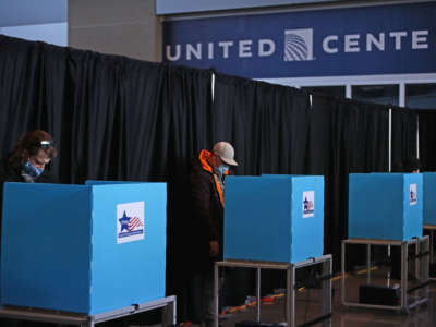 Voters use socially distanced voting machines set up in the east atrium of the United Center where a polling place with 70 machines was set up for the first time on November 03, 2020 in Chicago, Illinois.