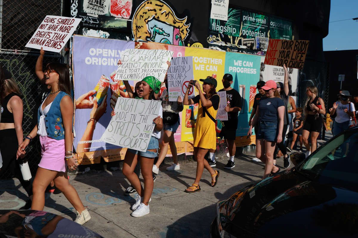 People march together to protest the Supreme Court's decision in the Dobbs v. Jackson Women's Health case on June 24, 2022, in Miami, Florida.