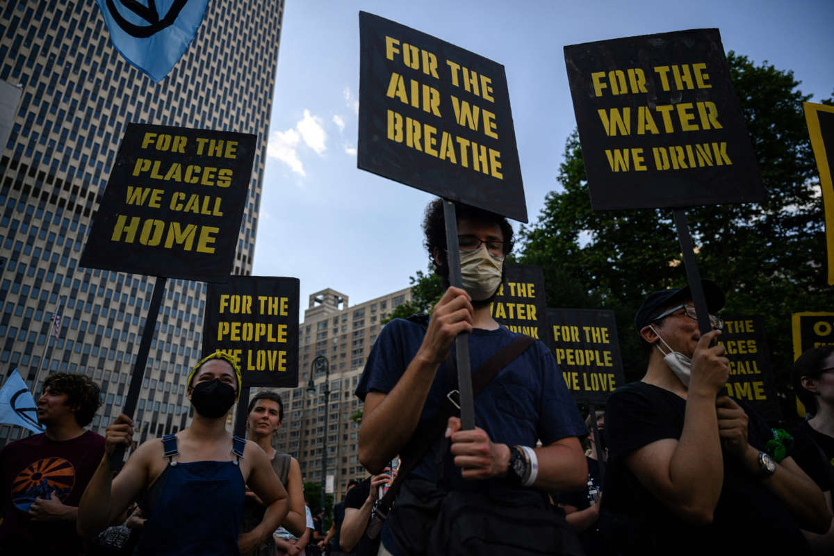 Climate activists attend a protest against a U.S. Supreme Court ruling limiting government powers to curb greenhouse gases, on June 30, 2022, in New York City.