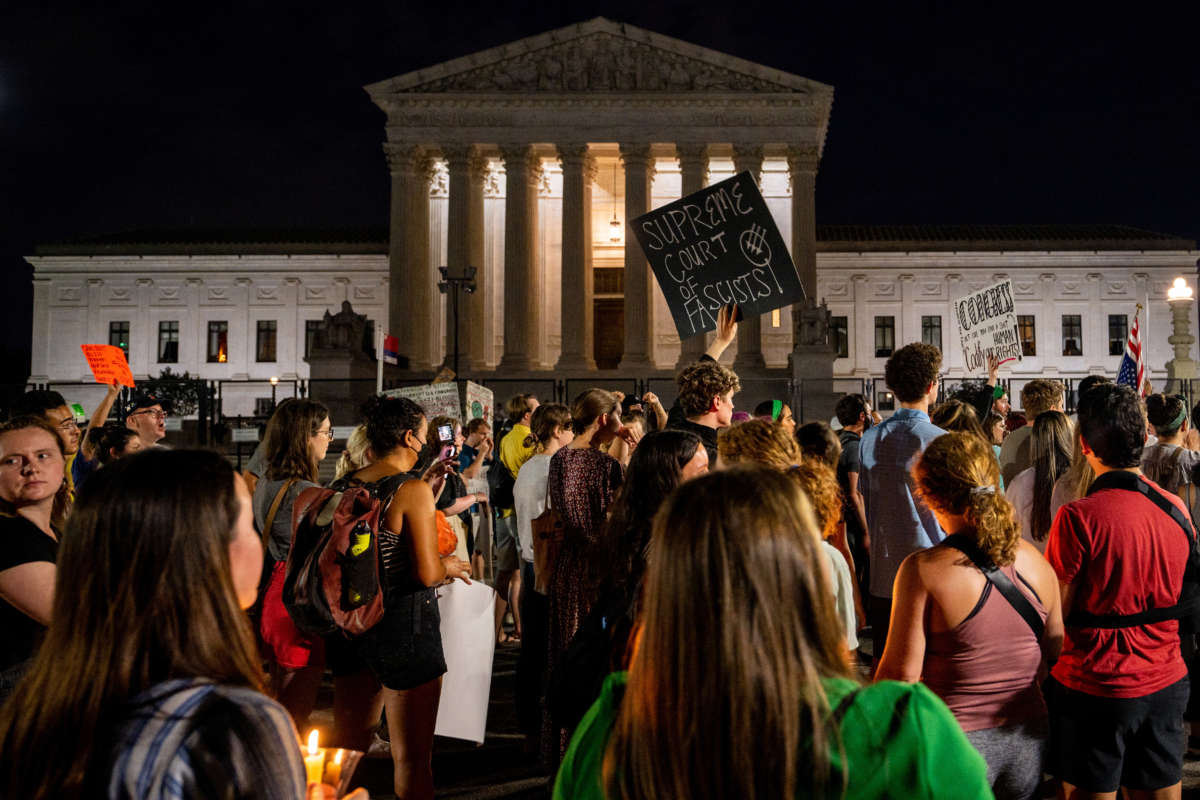 Protesters attend a candlelight vigil in front of the U.S. Supreme Court to denounce the court's decision to end federal abortion rights protections on June 26, 2022, in Washington, D.C.