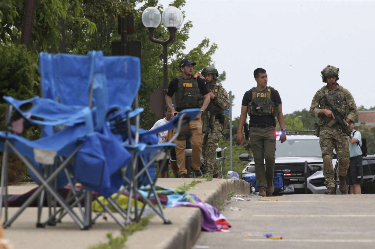 Law enforcement officers from multiple jurisdictions investigate the area in Highland Park, Illinois, on July 4, 2022, after a shooter fired on the Chicago suburb's Fourth of July parade.