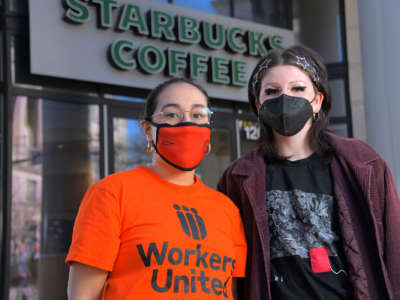 Stephanie Hernandez, organizer with Workers United (left) and Kieren Levy, a barista who works at the Mount Vernon Starbucks on North Charles Street pose outside the establishment.