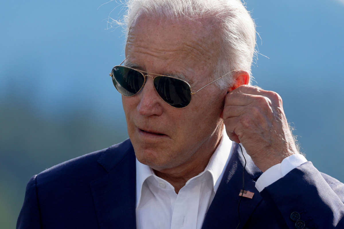 President Joe Biden adjusts his headphone during a press statement on the first day of the G7 leaders' summit held at Elmau Castle, southern Germany on June 26, 2022.