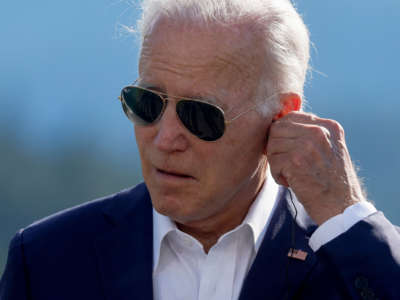 President Joe Biden adjusts his headphone during a press statement on the first day of the G7 leaders' summit held at Elmau Castle, southern Germany on June 26, 2022.