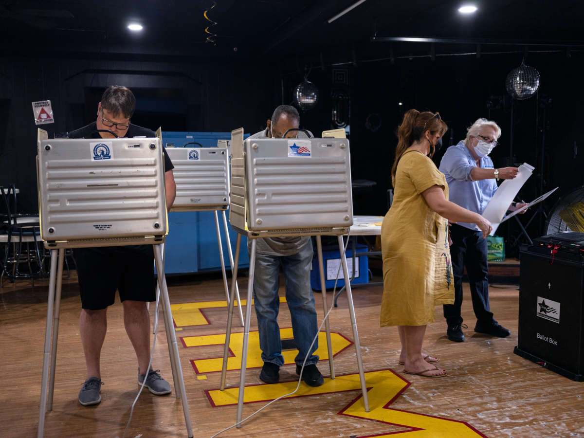 People vote at booths