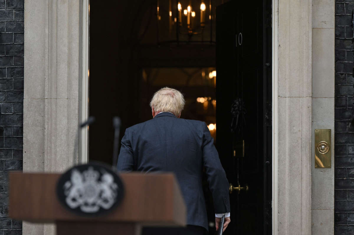 Britain's Prime Minister Boris Johnson walks back into 10 Downing Street in central London after making a statement on July 7, 2022.