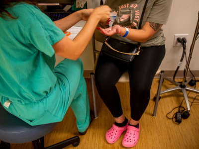 A resident gives a woman medication to terminate her pregnancy the day before the Supreme Court overturned Roe v. Wade at the Center for Reproductive Health clinic on June 23, 2022, in Albuquerque, New Mexico.