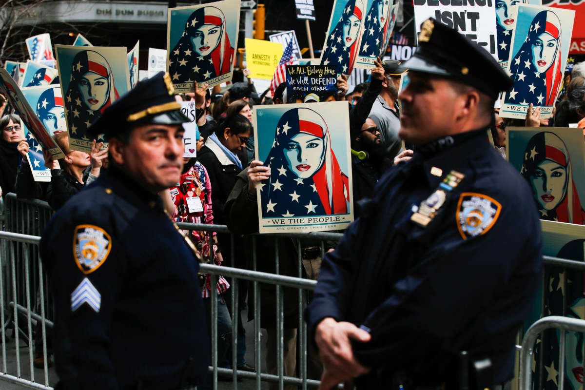 NYPD officers stand by as people take part in a rally in a show of solidarity with Muslims in the U.S. at Times Square on February 19, 2017, in New York City.