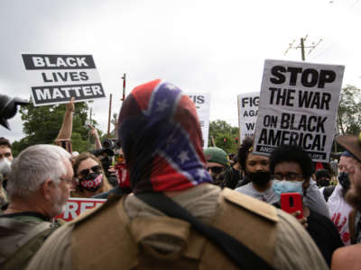 Antiracist and antifacist protesters face off against far right militias and white pride organizations near Stone Mountain Park in downtown Stone Mountain, Georgia, on August 15, 2020.