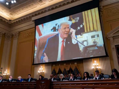 Donald trump is seen on a projection screen during the January 6th hearings