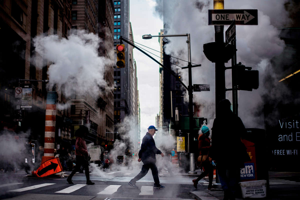 A man walks across an incredibly smoggy New York intersection