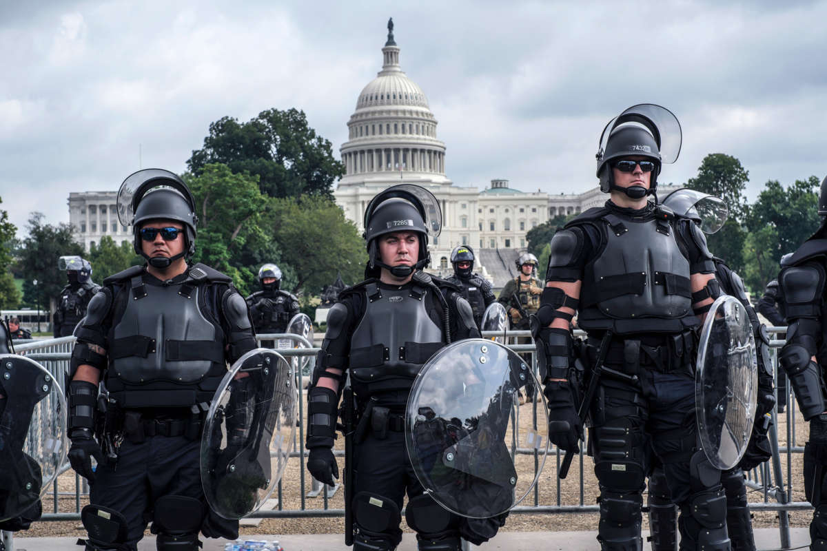Riot cops glare while standing in front of the U.S. capitol